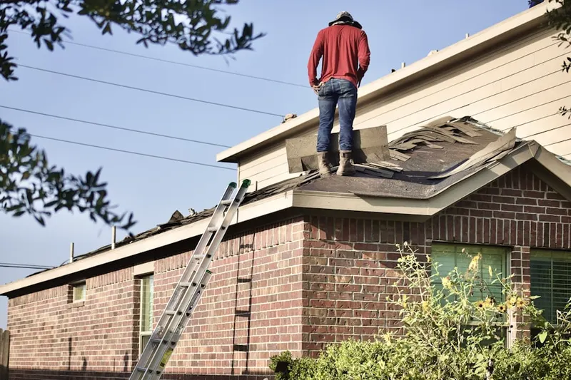 Professional roofer working on a residential roof in Vantage Glen